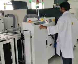 Indian factory workers assembling telecom equipment with 'Make in India'